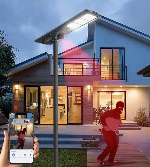 Smart security camera light detecting an intruder, with phone alert
